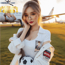 a woman holding a soccer ball in front of an airplane with the words museum bola on it