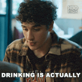 a man in a plaid shirt with the words drinking is actually on the bottom