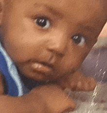 a close up of a baby 's face with a blurred background