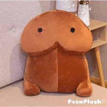 a peenplush stuffed animal is sitting on a bed