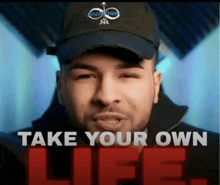 a man wearing a hat with the words take your own life below him