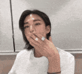 a man with long hair and a ring on his finger