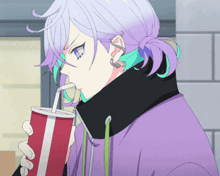 a person with purple hair is drinking from a red and white cup