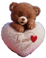 a brown teddy bear laying on a white heart shaped pillow that says te amo