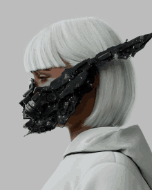 a woman with white hair is wearing a futuristic mask on her face