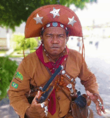 a man wearing a hat and holding a gun has a patch on his sleeve that says brasil