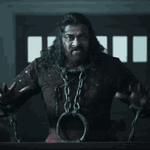 a man with long hair and chains around his neck screams