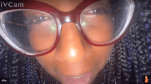 a close up of a woman 's face with glasses and the words ivcam above her