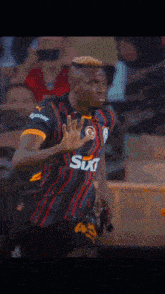 a soccer player wearing a sixt shirt runs towards the camera
