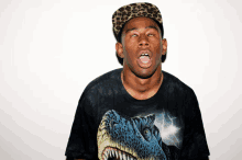 a man wearing a black shirt with a dinosaur on it making a funny face