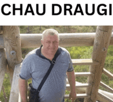 a man in a blue shirt is standing on a wooden railing with the name chau  draugi written above him