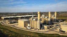 an aerial view of a large power plant with a blue sky