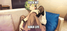 a man with green hair is sitting on a couch with the words " fuck my baka life "