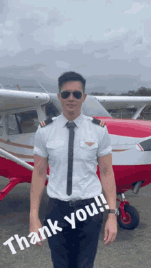 a man in a pilot 's uniform stands in front of a red and white plane with the words thank you written below him