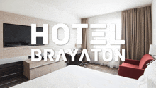 a hotel brayaton room with a bed and a red chair