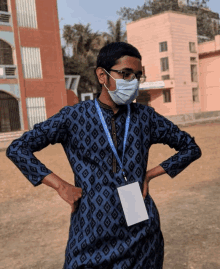 a man wearing a face mask and a lanyard with a name tag on it