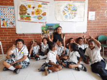 a group of children are sitting on the floor in front of a white board that says " ciencias naturales "