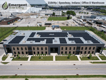 an aerial view of a large building with solar panels on it