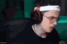 a man wearing headphones and a headband with nike on it