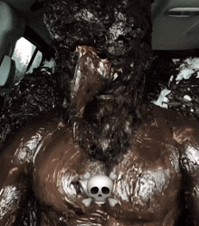 a person with a skull and crossbones on their chest is covered in mud