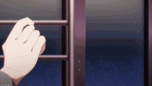 a close up of a person 's hand behind bars with the words omake gif anime visible