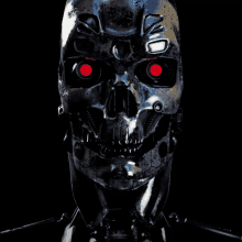 a close up of a robot skull with red eyes on a black background