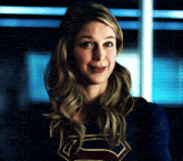 a woman in a superman costume is smiling