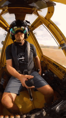 a man in a helmet is sitting in the cockpit of a plane with the letters gsa on the side