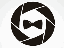 a black and white circle with a bow tie in the middle