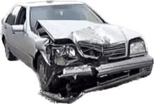 a silver car with a damaged front end and hood on a white background .