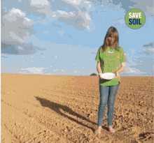 a boy is sitting at a table holding a fork and knife with a save soil sticker on the corner