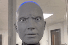 a close up of a robot 's head with a blue light on it