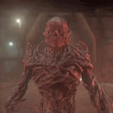 a red monster with a skull on his head is standing in a dark room