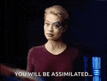 a person is putting a bandage on a woman 's head and says `` you will be assimilated '' .