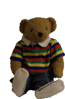 a teddy bear wearing a colorful striped shirt and jeans