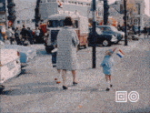 a woman and two children are standing on a sidewalk in front of a van with the license plate sn-954f