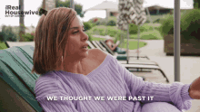 a woman in a purple sweater sits in a chair with the words " we thought we were past it " above her