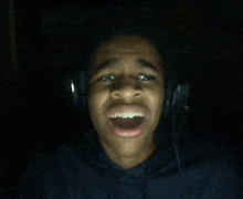 a man wearing headphones is making a funny face