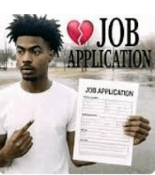 a man is holding a job application with a broken heart on it and pointing at it .