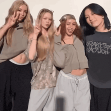 four girls are posing for a picture and one of them is wearing a shirt that says ' space ' on it