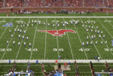 a football field with a mustang logo on the field