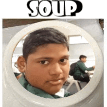 a young boy is sitting in a circle in front of a mirror with the word soup above him .