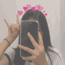 a girl is taking a picture of herself with hearts on her hair