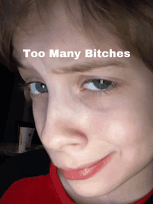 a close up of a child 's face with the words " too many bitches " written above it