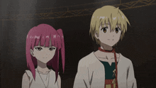 a boy and a girl are standing next to each other in a dark room