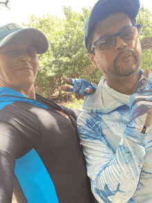 a man and a woman are posing for a picture and the man is wearing a blue shirt