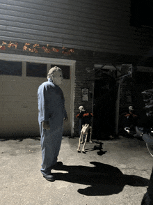 a man in a mask is standing in front of a garage