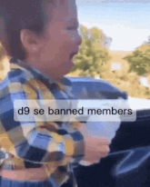 a child is crying in a car with the words d9 se banned members above him