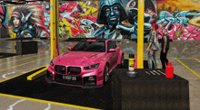 a pink car is parked in a garage with graffiti on the wall