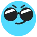 a blue smiley face with sunglasses and a tongue sticking out of it .